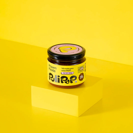 Prawn Pickle by PuliPOP 300g glass jar with yellow label on yellow pedestal
