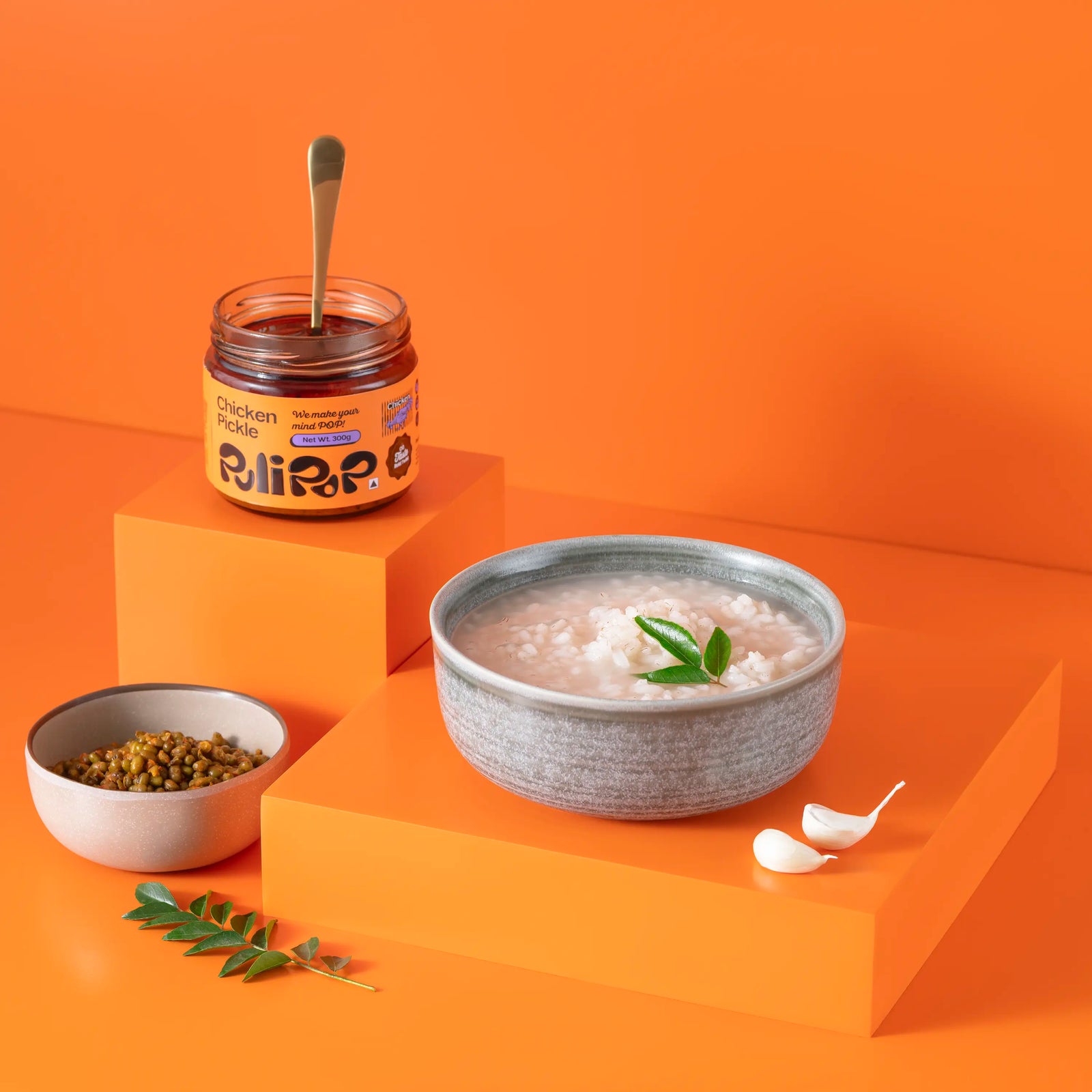 Chicken Pickle by PuliPOP with a bowl of rice kanji, lentils and curry leaves