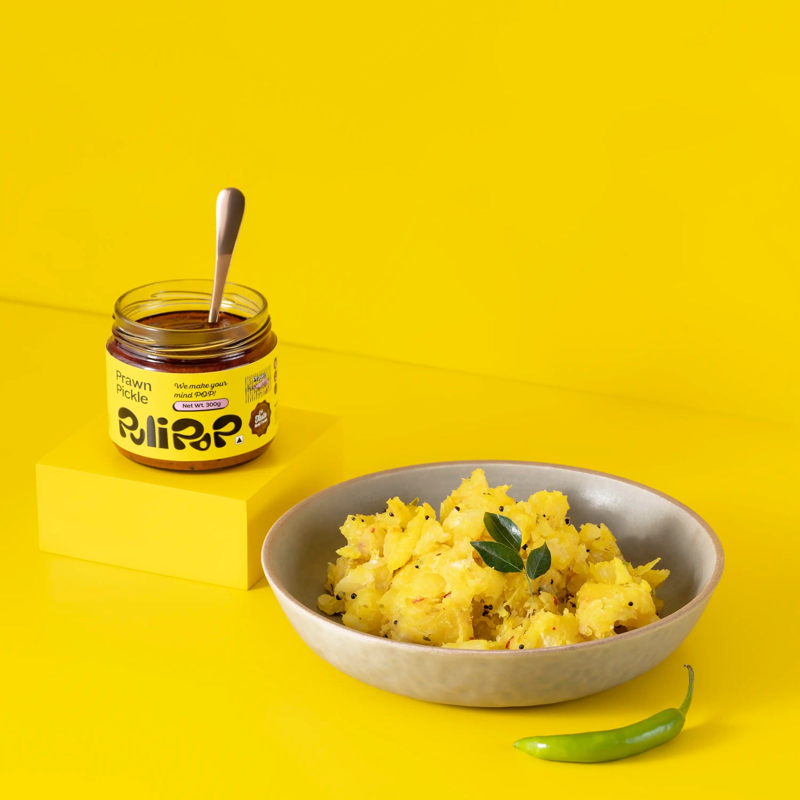 Prawn Pickle by PuliPOP with an open jar and a bowl of upma with green chilli