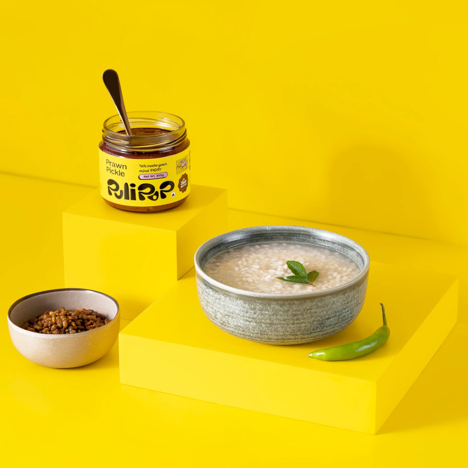 Prawn Pickle by PuliPOP with a bowl of rice kanji, lentils and green chilli