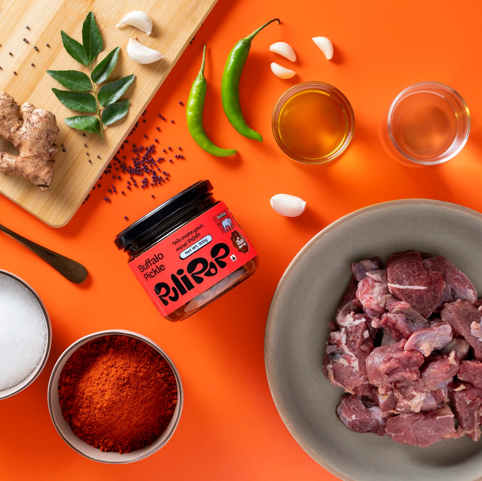 Buffalo Beef Pickle by PuliPOP surrounded by raw buffalo meat, green chillies, gingelly oil and spices